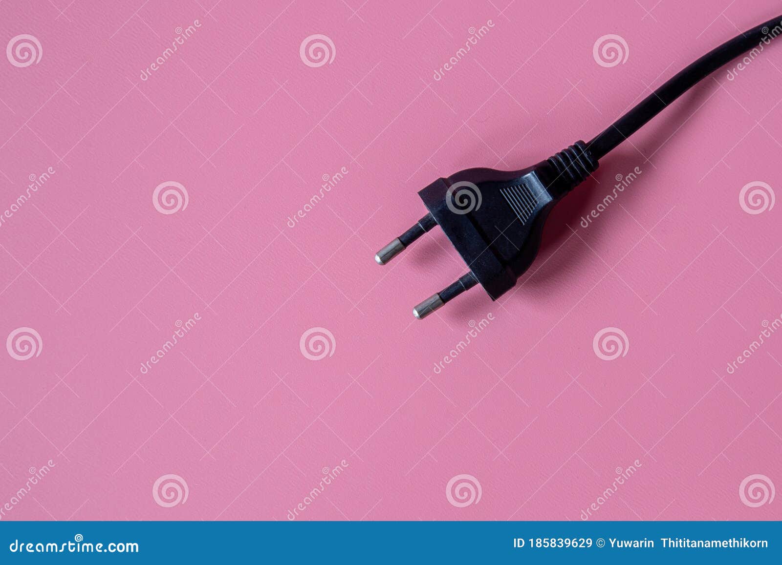 Black Electrical Plug and Electrical Cord Pink Background. Stock Image