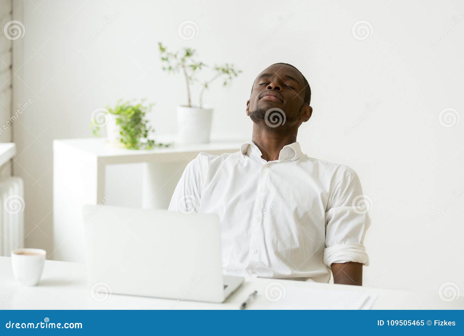 black employee taking rest doing exercise for relaxation at work