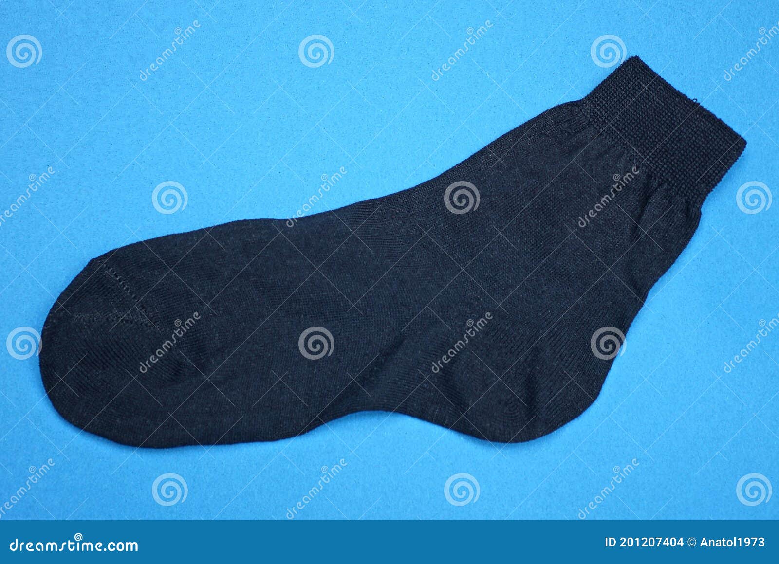 Black Fabric Sock Lies on a Blue Table Stock Photo - Image of funny ...