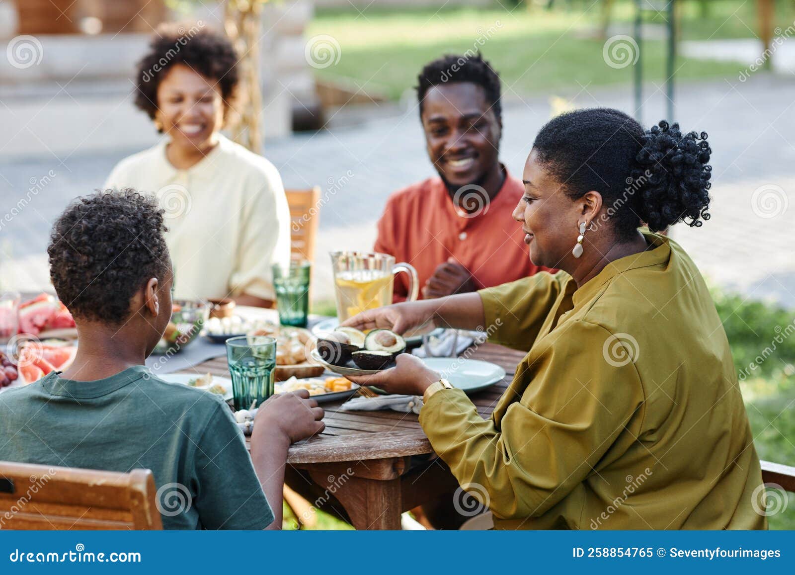 Black Family Enjoying Dinner Together Outdoors Stock Image - Image of