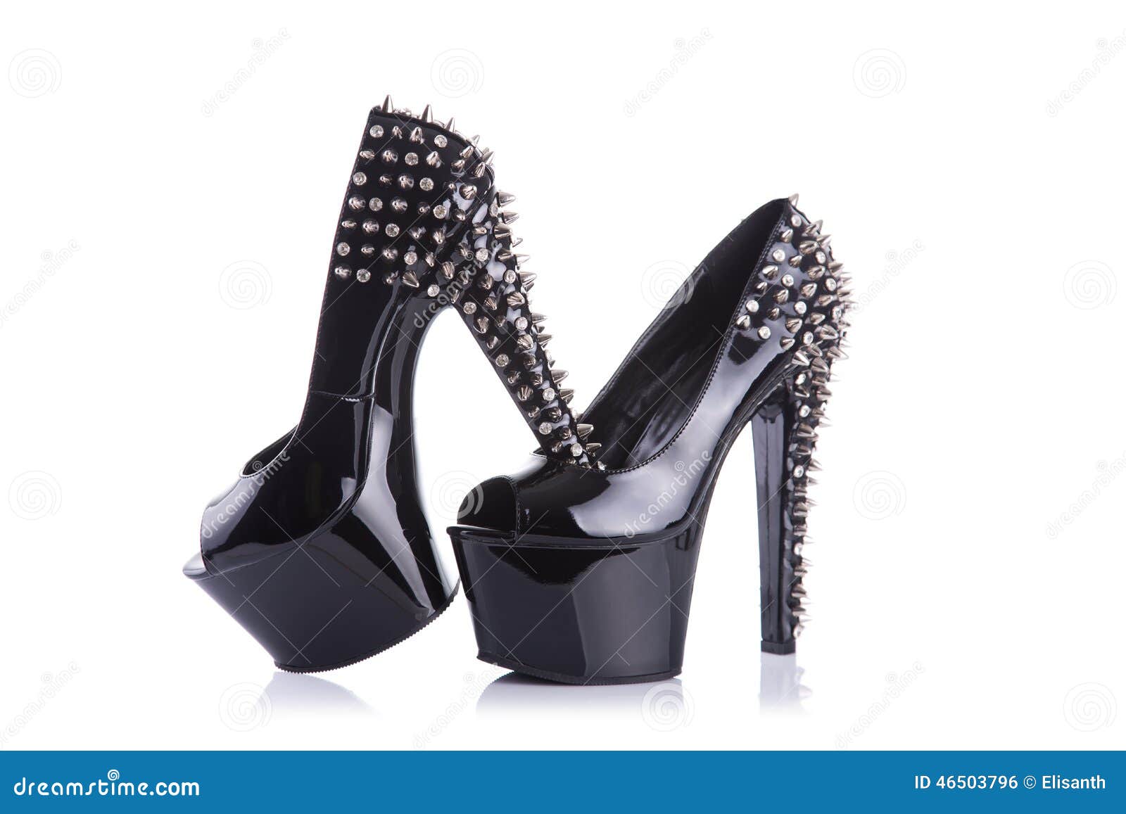 Black fashionable high heel shoes with spikes and studs, isolated on white background