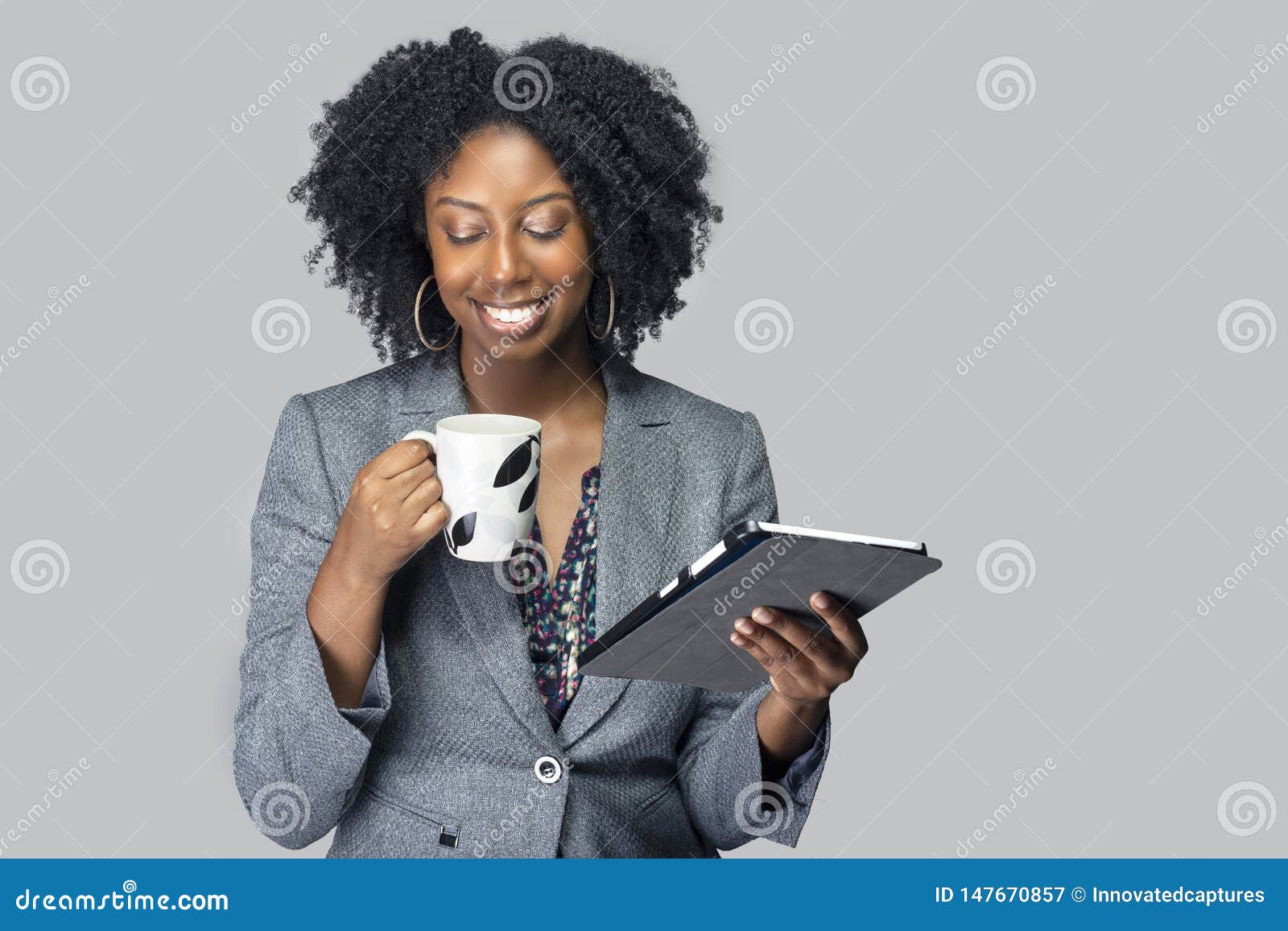 black female businesswoman keynote speaker posing with a tablet and coffee