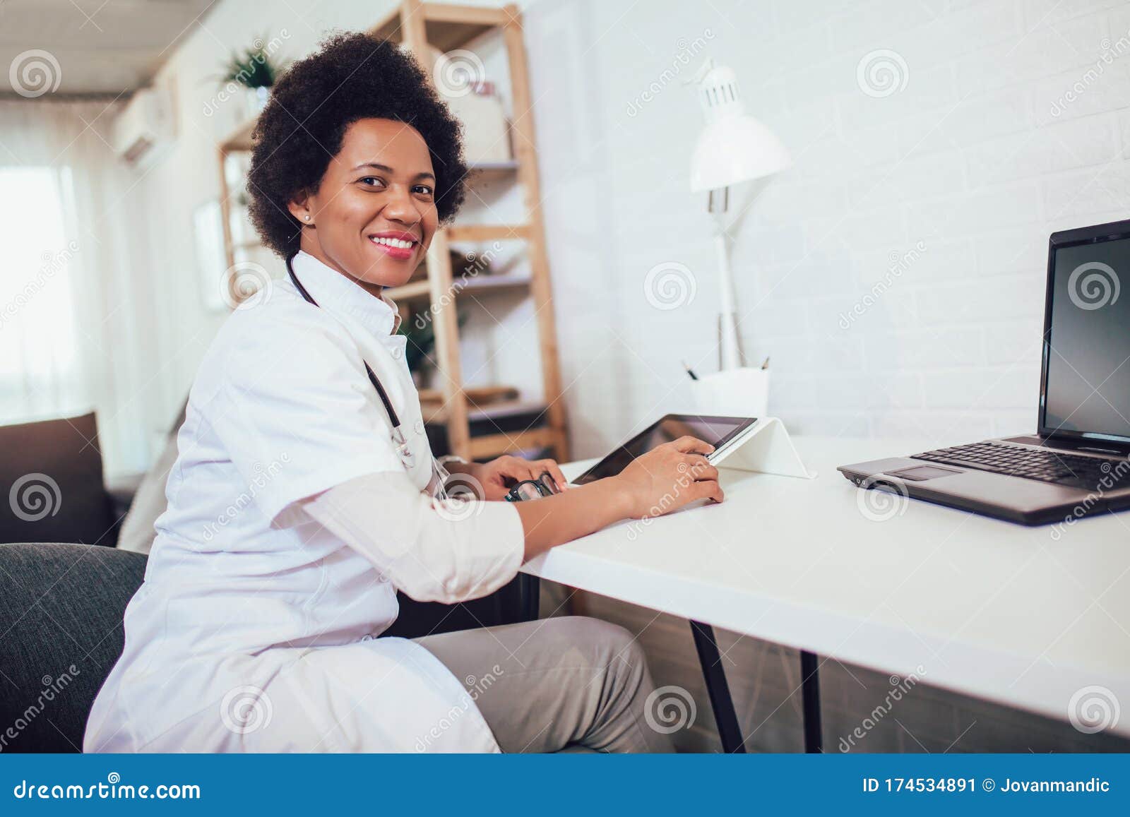 Female Doctor Wearing White Coat at Work in an Office Stock Image