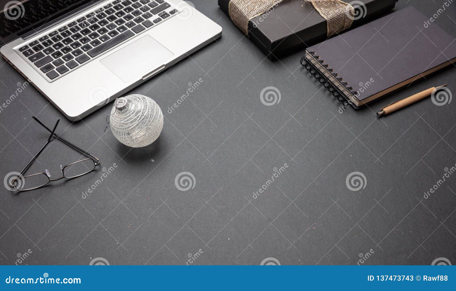 Black Gift Box With Shiny Ribbon On Black Office Desk Stock Image