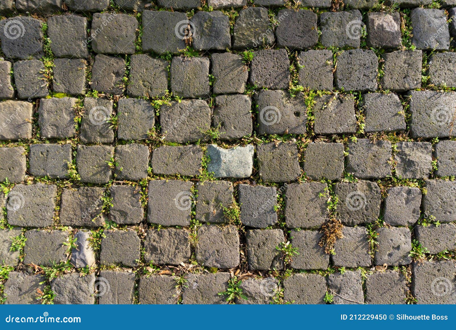 black gray basalt lava rectangular pavement cobblestones in square format texture. basalt lava paving stones textures.
