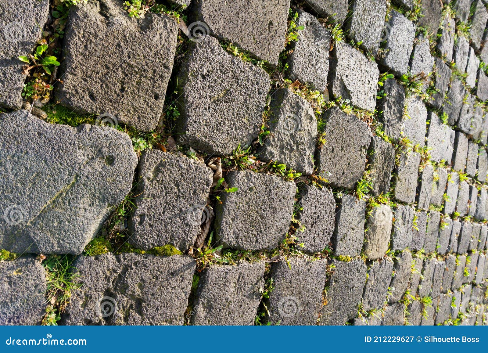 black gray basalt lava rectangular pavement cobblestones in square format texture. basalt lava paving stones textures.