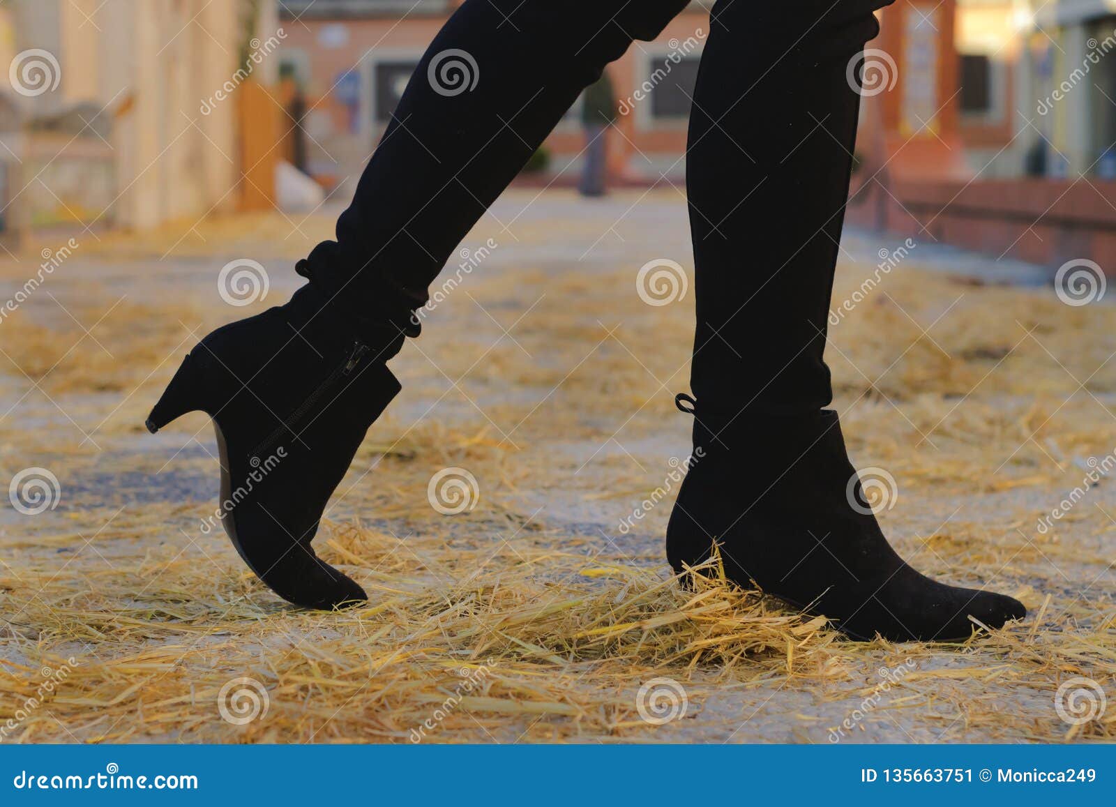 Black Heel Ankle Boots Walking on Yellow Straw Stock Image - Image of ...