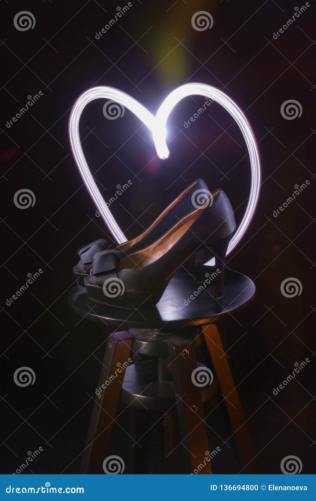 Black High Heels Shoes On Chair At Black Background With Heart