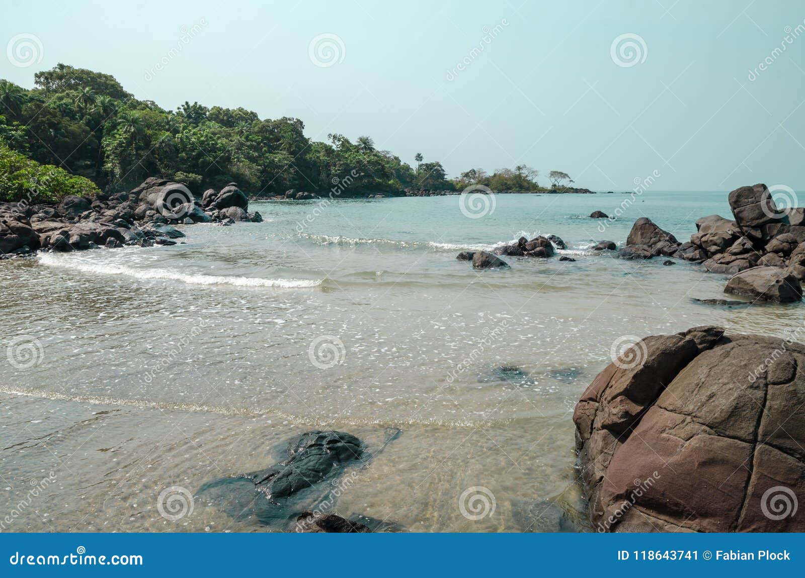 black johnson beach in sierra leone, africa with calm sea, ropcks, and deserted beach