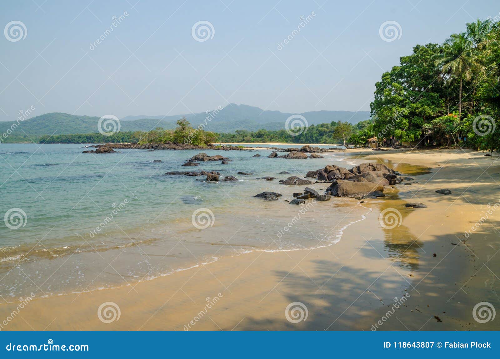 black johnson beach in sierra leone, africa with calm sea, ropcks, and deserted beach