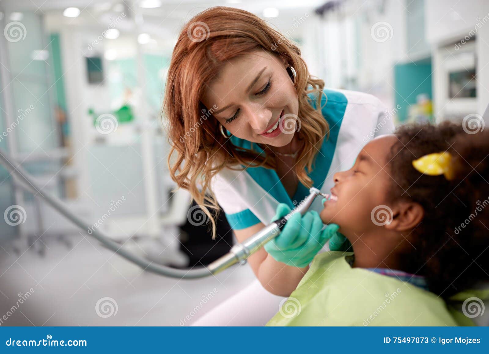 black kid with female dentist in dental clinic