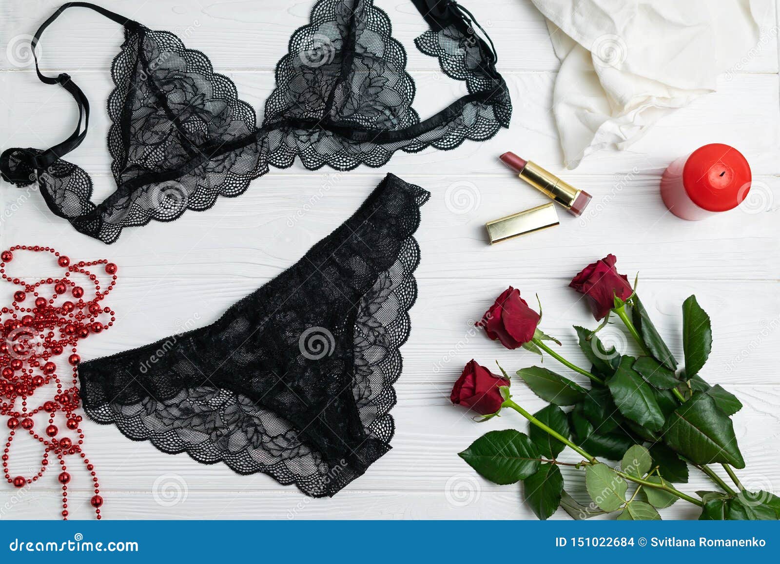 Romantic couple in lingerie with red rose on black background. Stock Photo