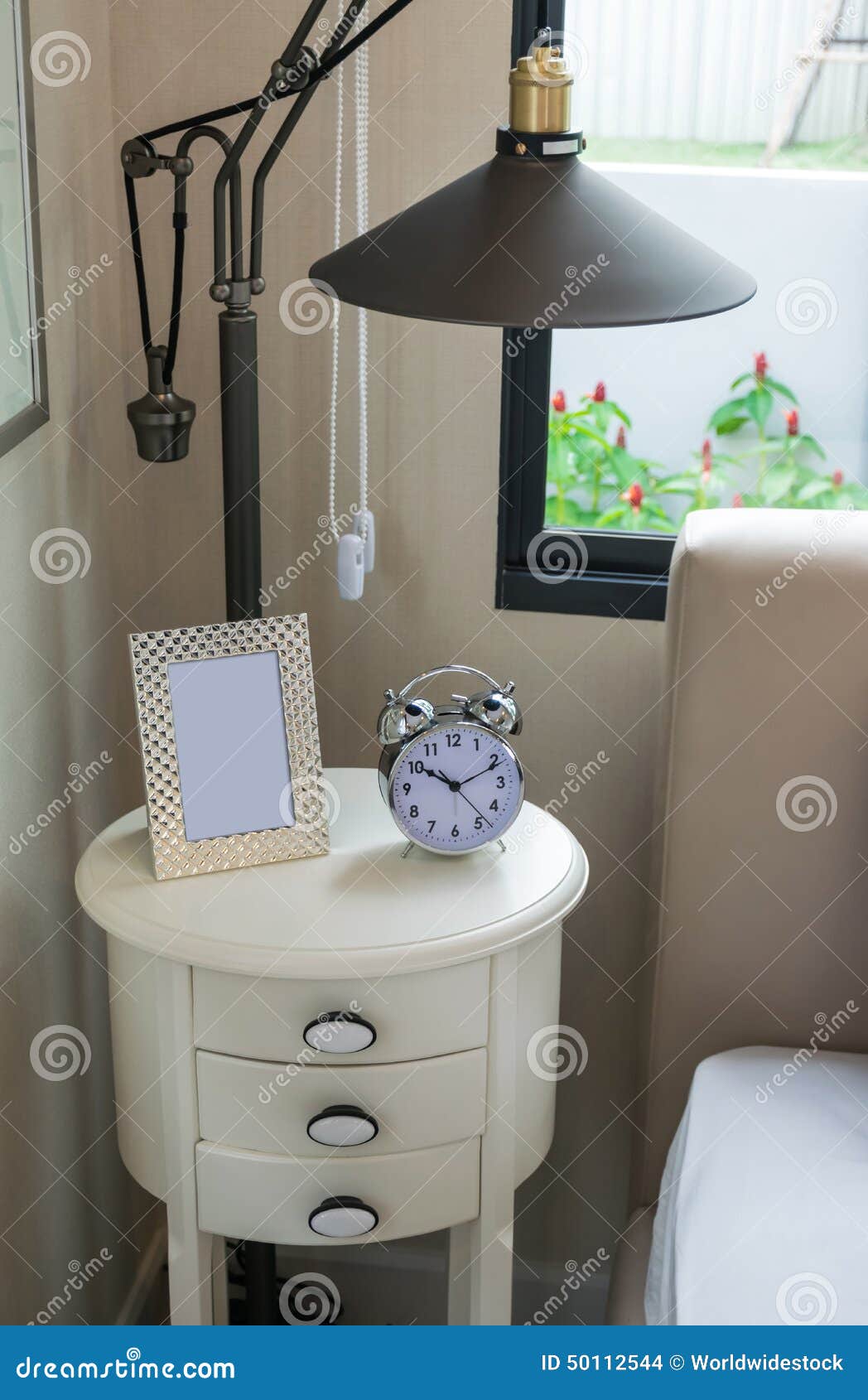 Black Lamp, Picture Frame and Alarm Clock on Table Stock Photo Image