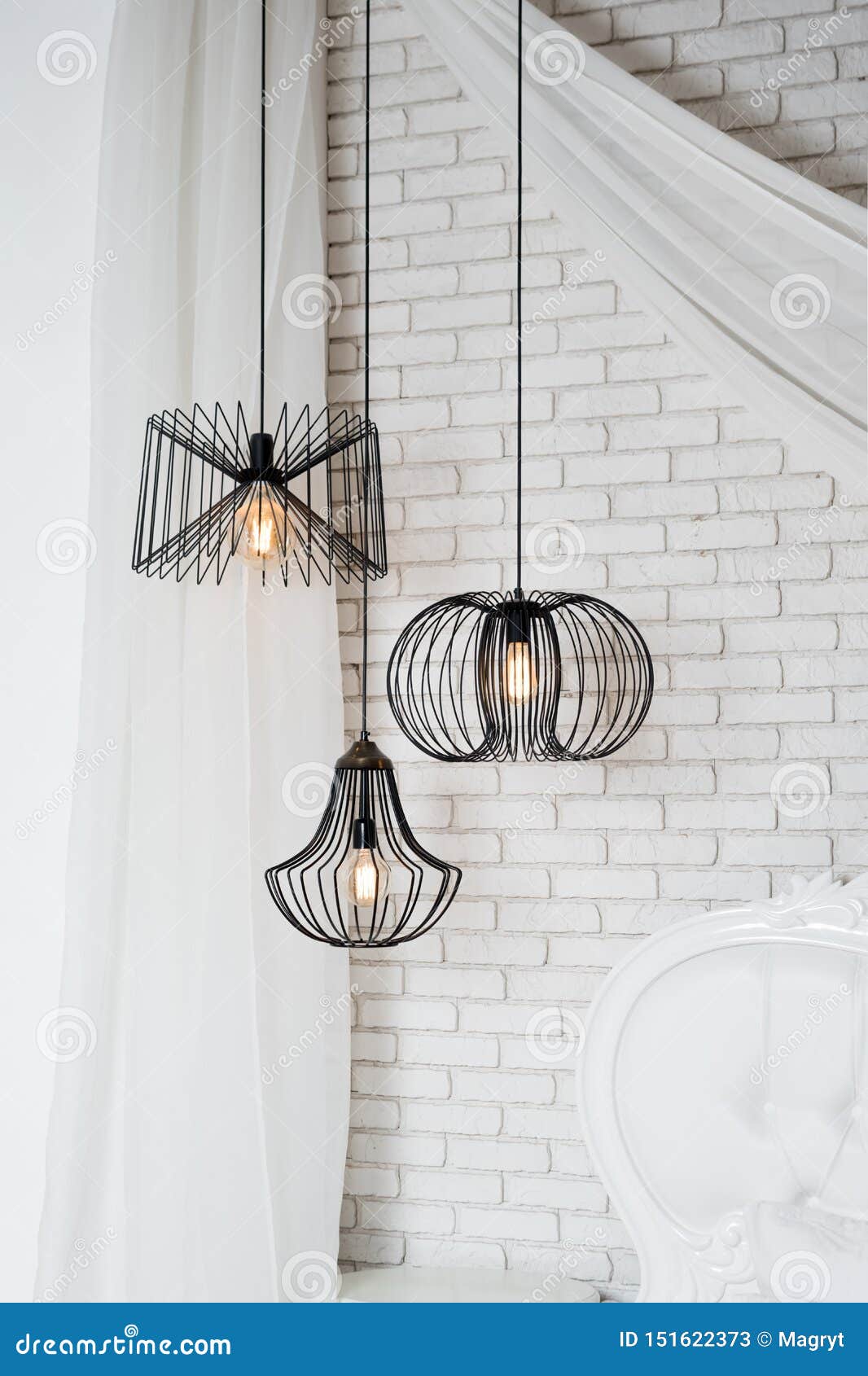Black Lamps in Light Bedroom Interior. Three Modern Black Lamps Hanging