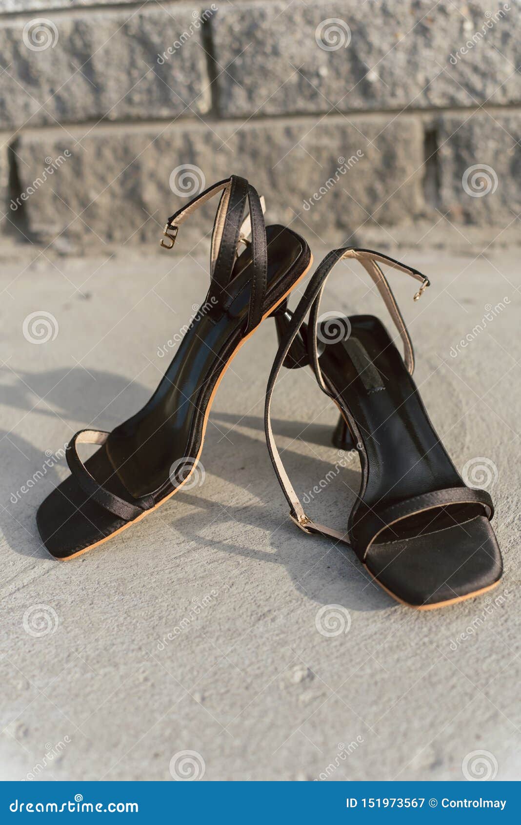 Black Leather Open Sandals with Heels Stand on the Asphalt in the Sun ...