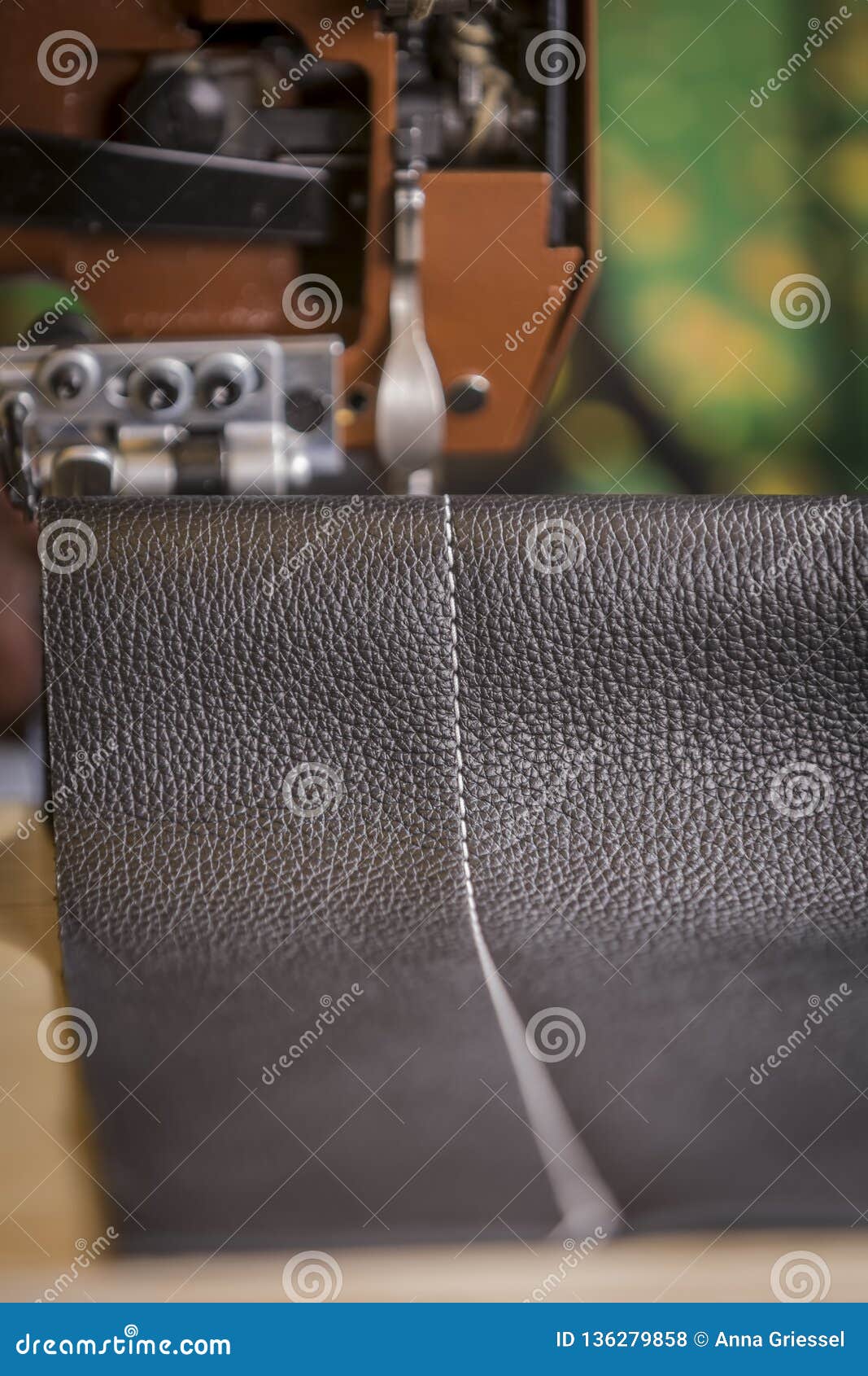 Black Leather Stitching in Front of a Commercial Sewing Machine Stock