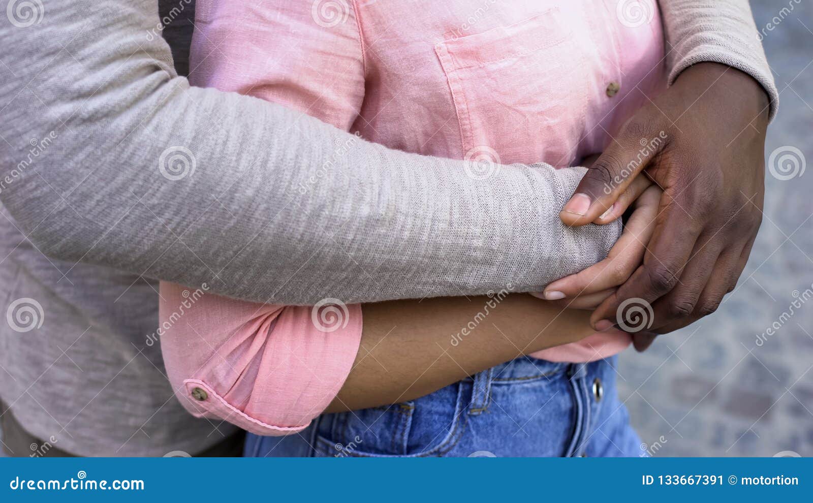 black male hugging girlfriend, romantic date in city, feeling safe in relations