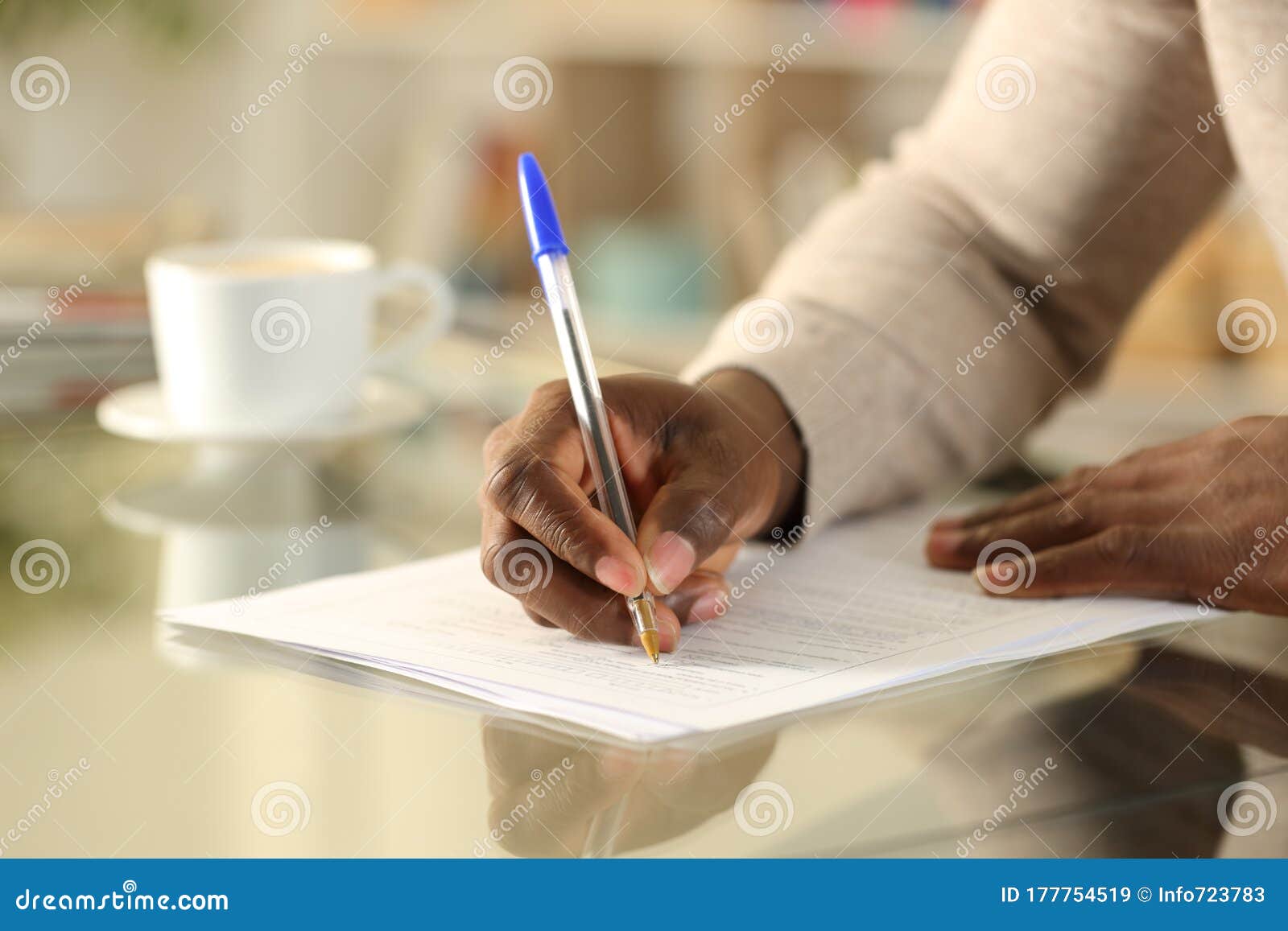 black man hands filling out form on a desk