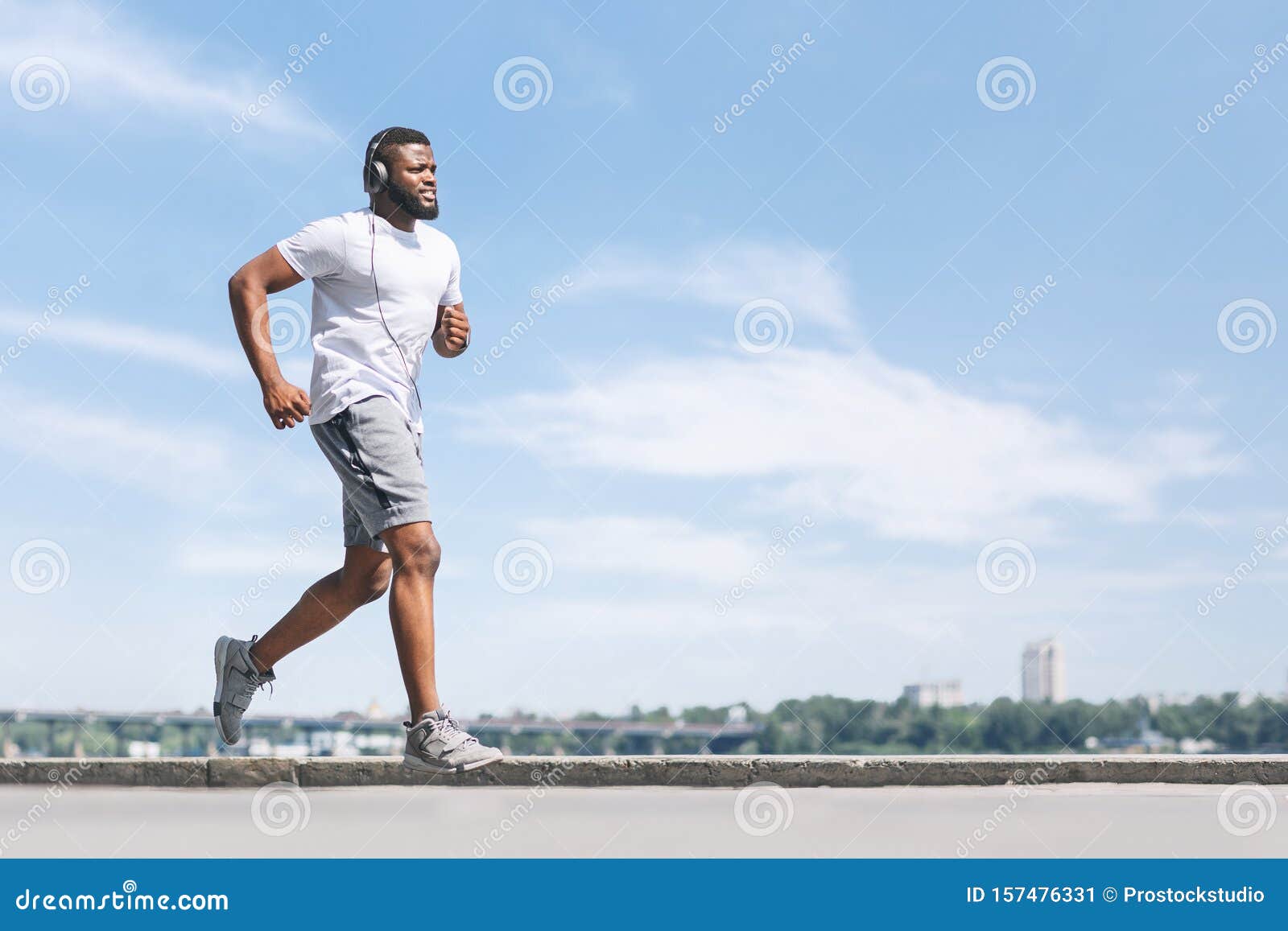 Young African-American black man jogging and running on a path and