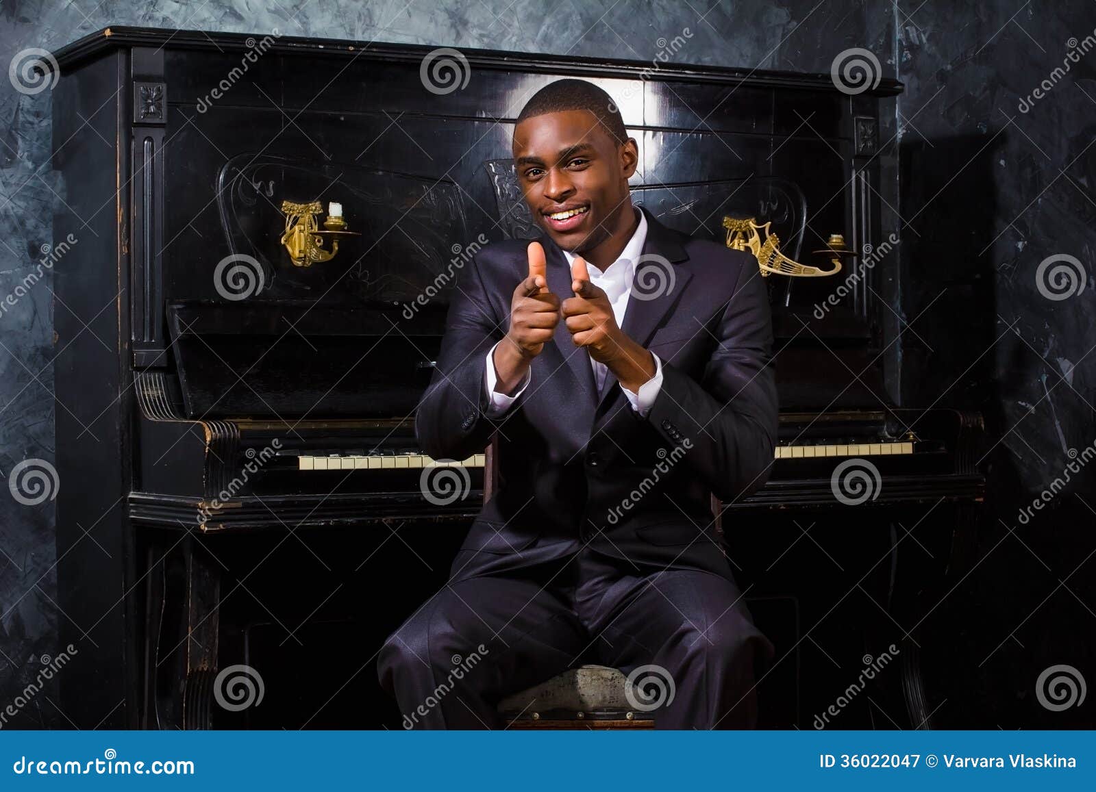 Black man near the piano stock image. Image of person 36022047