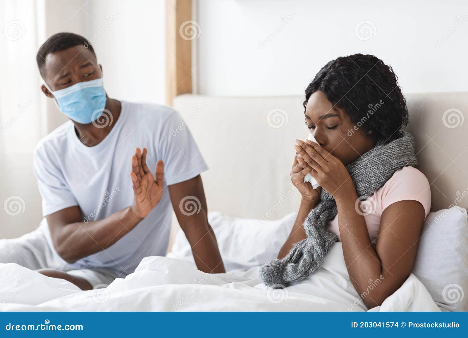 Black Man Wearing Face Mask While His Wife Is Sick Stock Photo Image