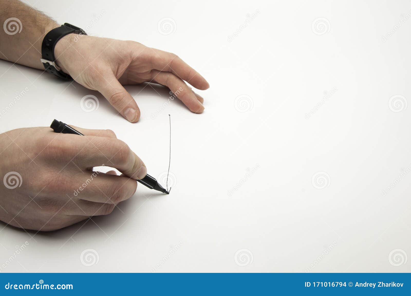 Black Marker in the Hands of a Man. Writes on a Blank Sheet of Paper ...