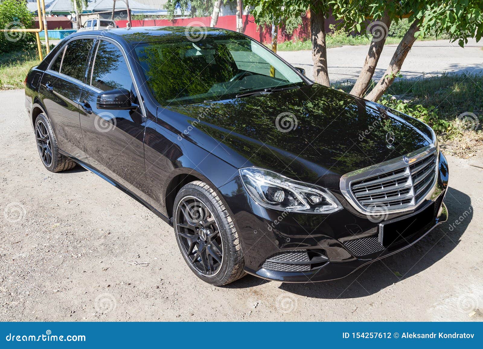 Black Mercedes Benz E Class 50 13 Year Front View With Dark Gray Interior In Excellent Condition In A Parking Space Near Green Editorial Photography Image Of Metallic E250