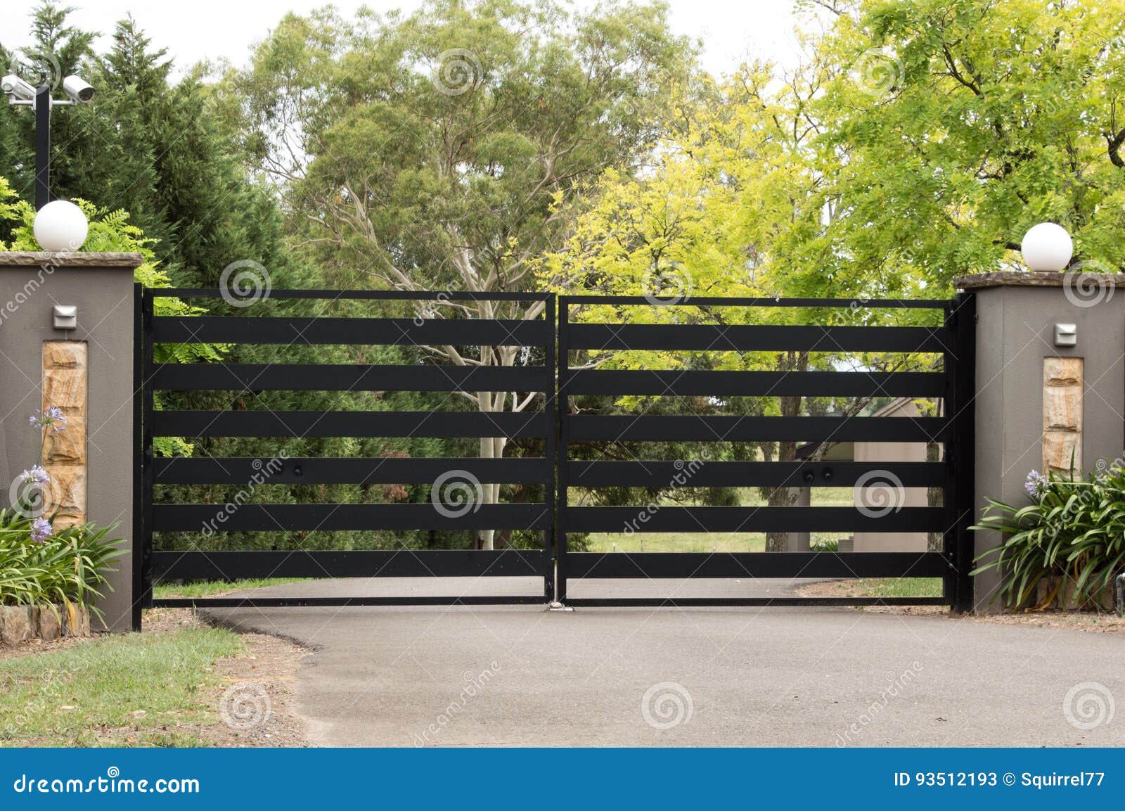 Black Metal Driveway Entrance Gates Set in Fence Stock Image - Image of