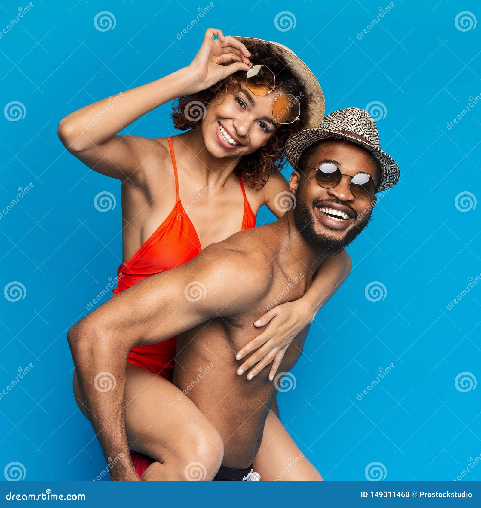 Girlfriend in black bikini riding on her man
