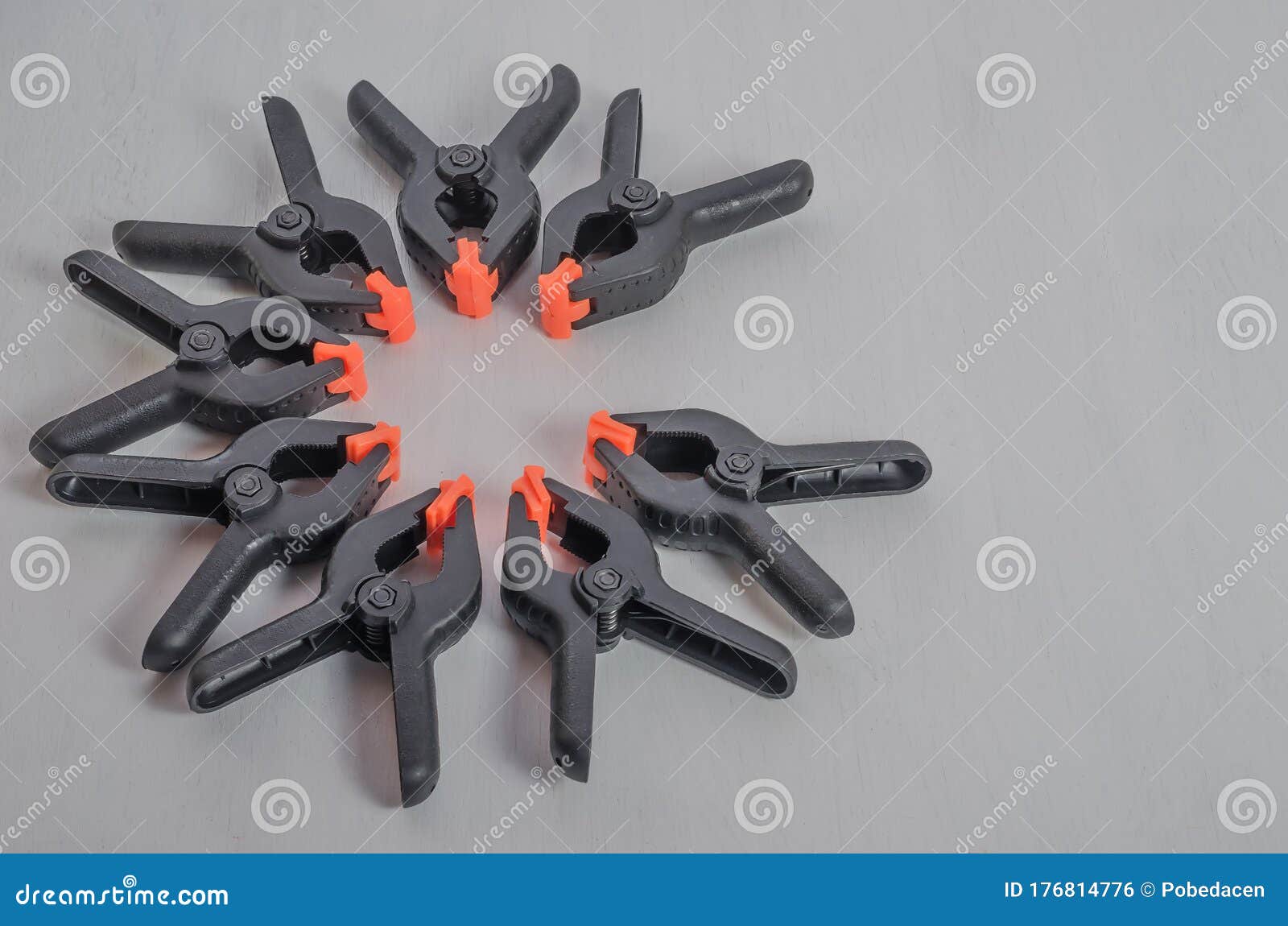Black and Orange Construction Clamps on a White Background. Set of