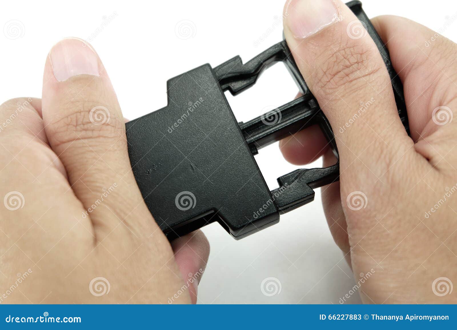 Black Plastic Lock Buckle Is Locked By Both Hands On White Background