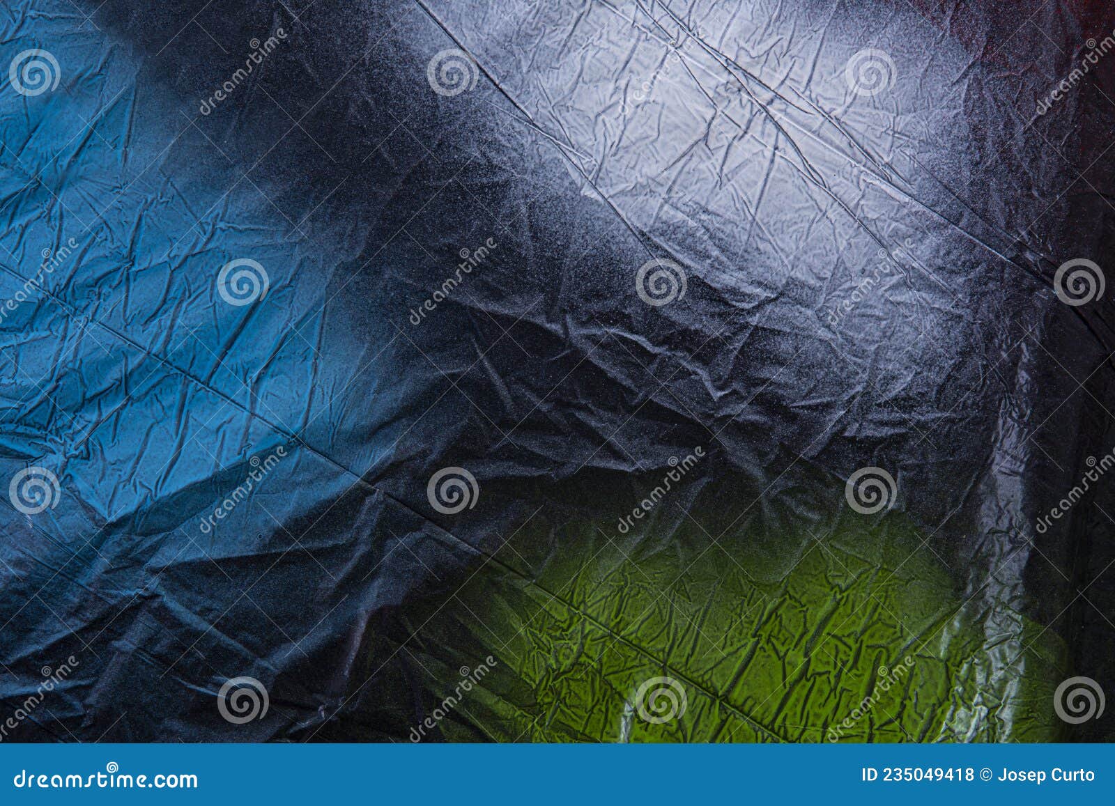 A Black Plastic Painted with Colored Spray Paint Blue, White and Green