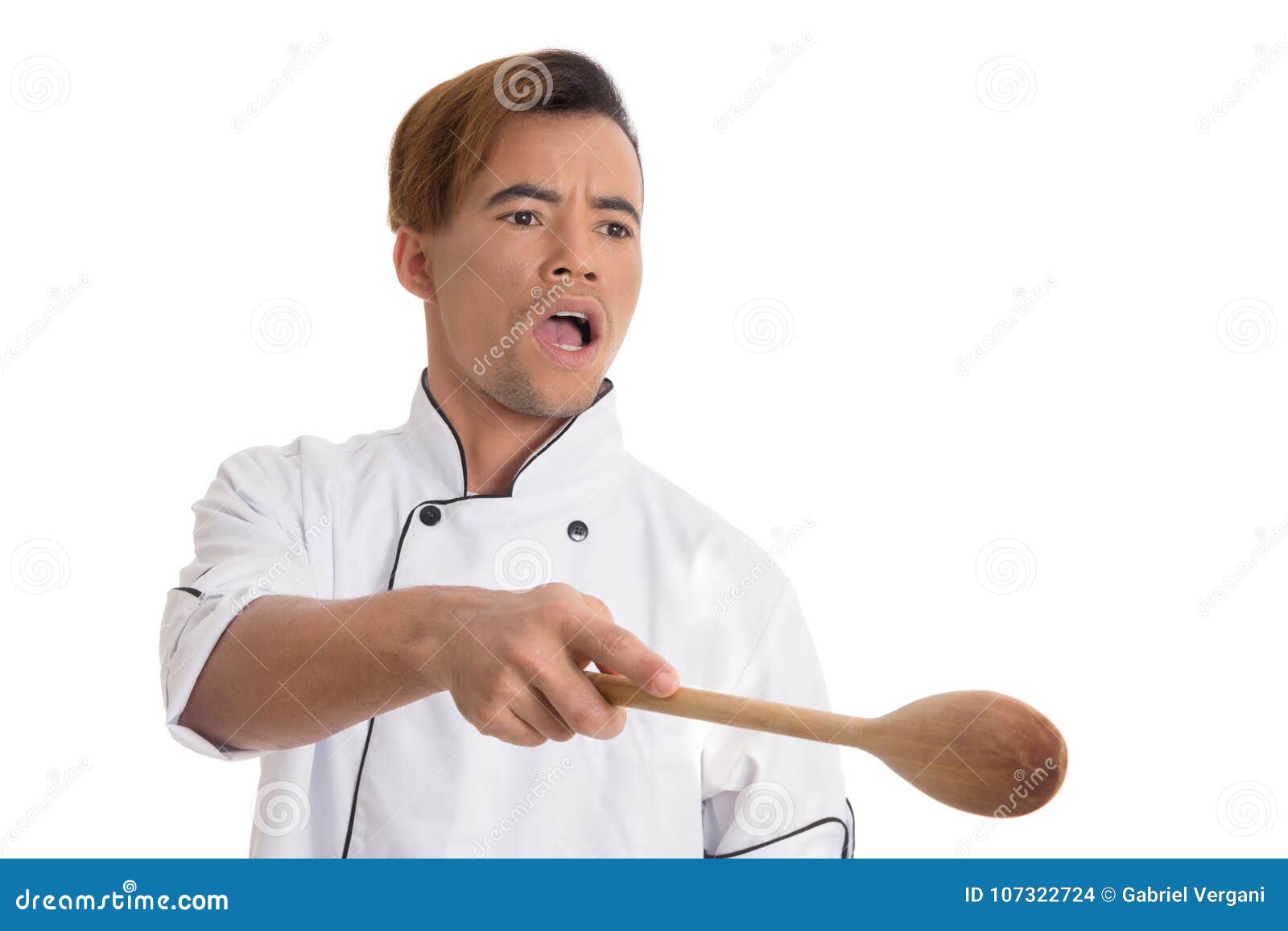 professional cook pointing with wooden spoon young black man is