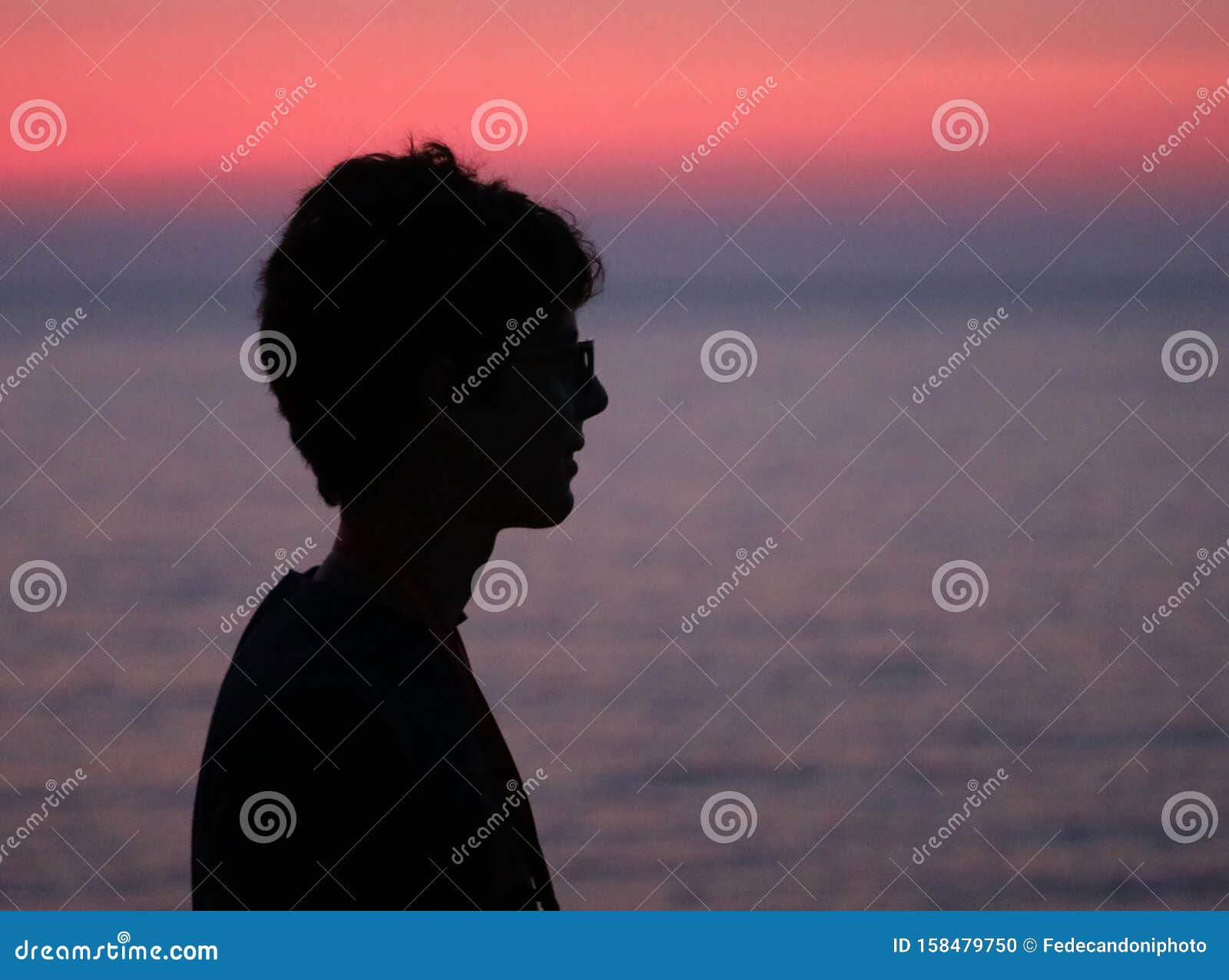 black profilo of young boy at sunset