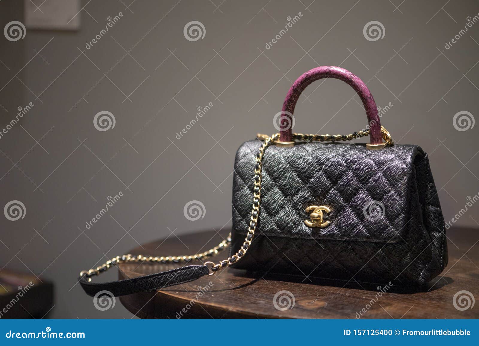 Authentic Black Chanel Bag Sitting on Table Editorial Image