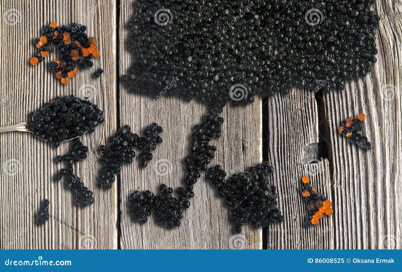 black and red caviare on wooden background. top view