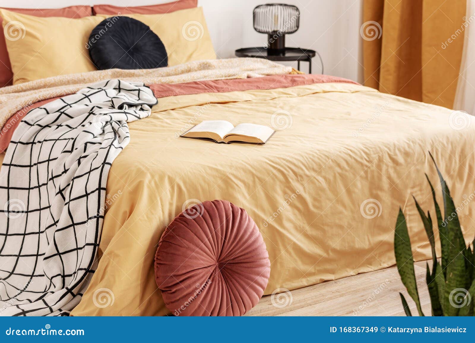 Black Velvet Pillow On Yellow Duvet In Trendy Bedroom Interior