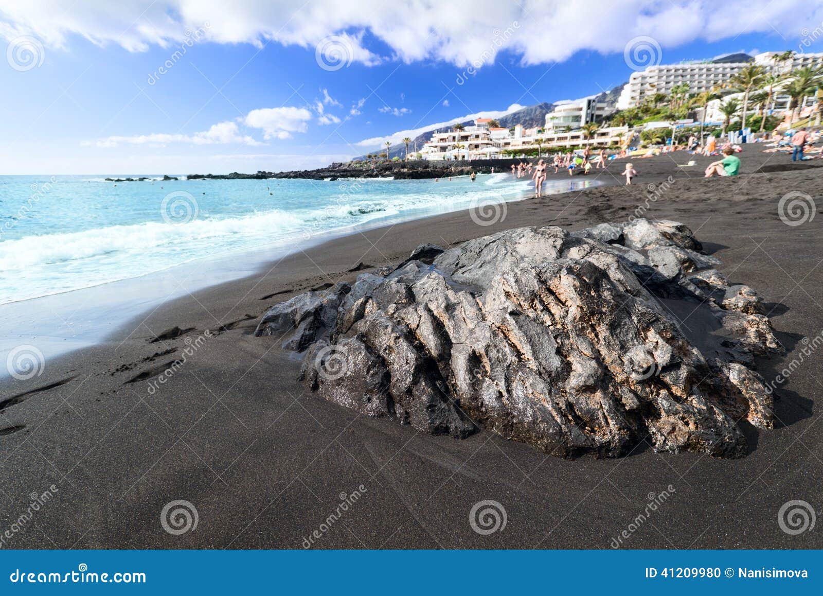 black sand beach at tenerife island spain wet rock