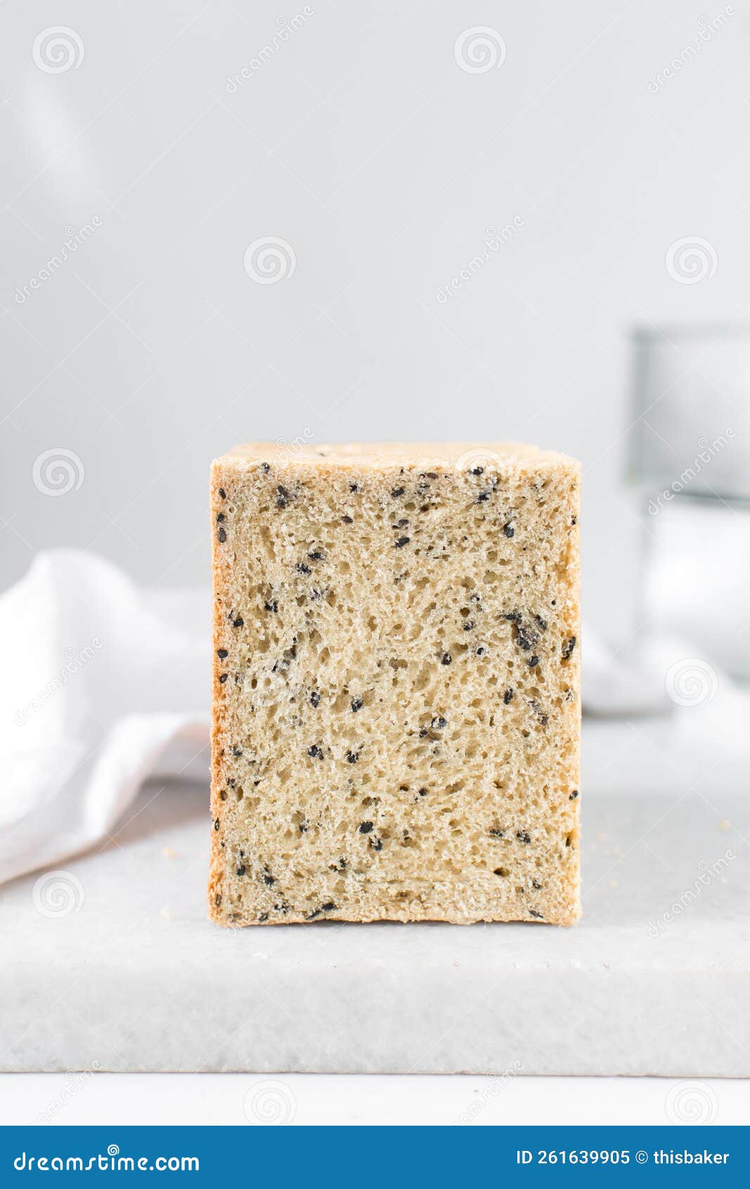 black sesame seed bread on a white chopping board