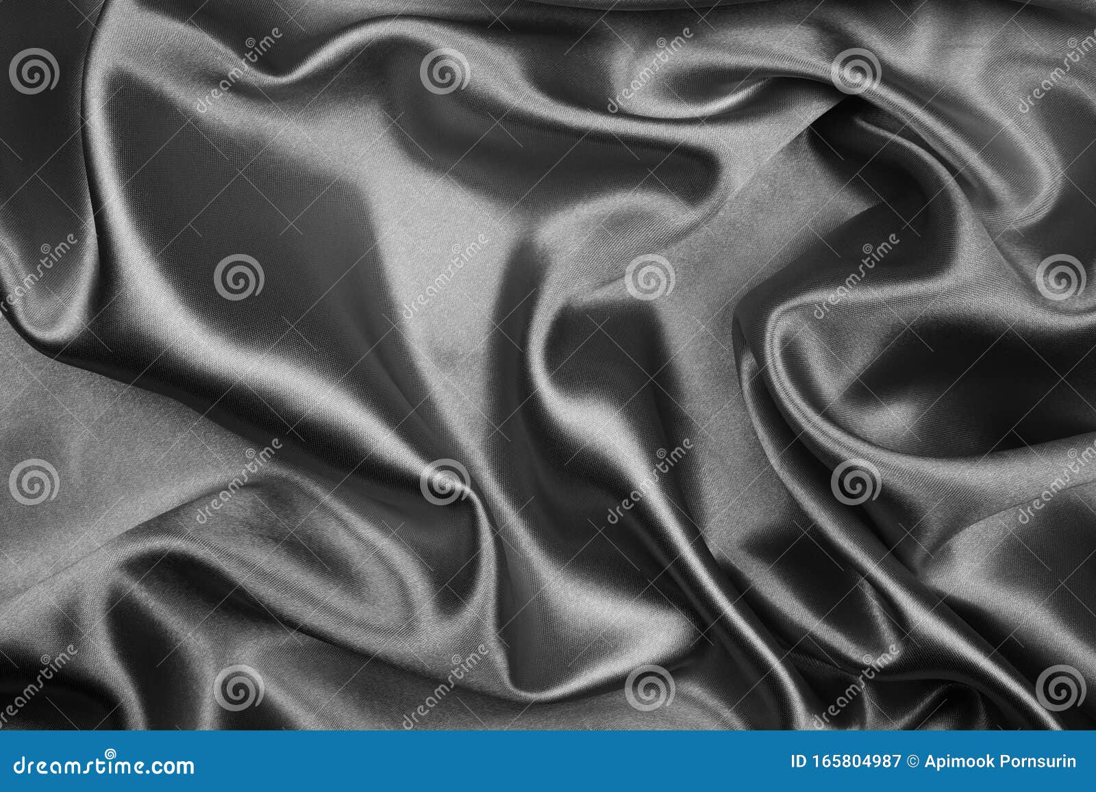 Black silk or satin fabric abstract background. Black abstract