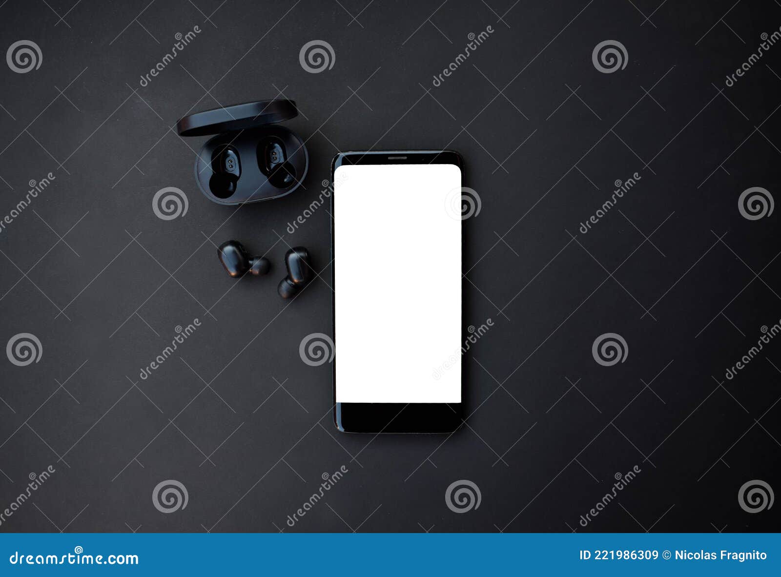 black smartphone and headset on black background