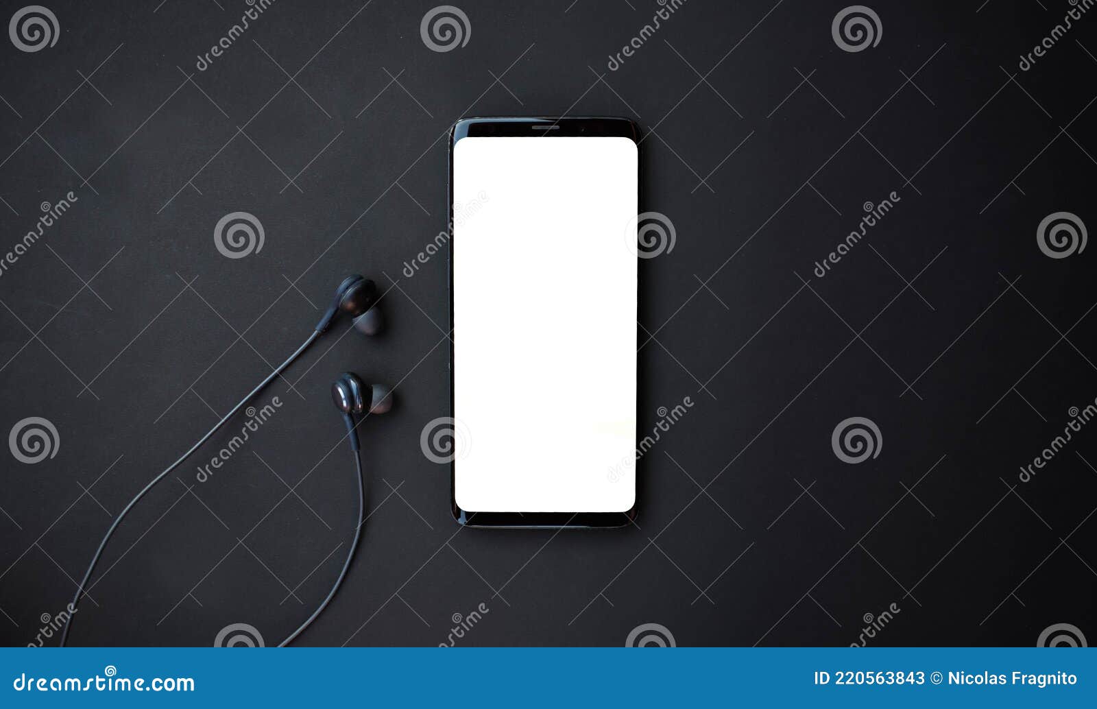 black smartphone and headset on black background. top view with copy space