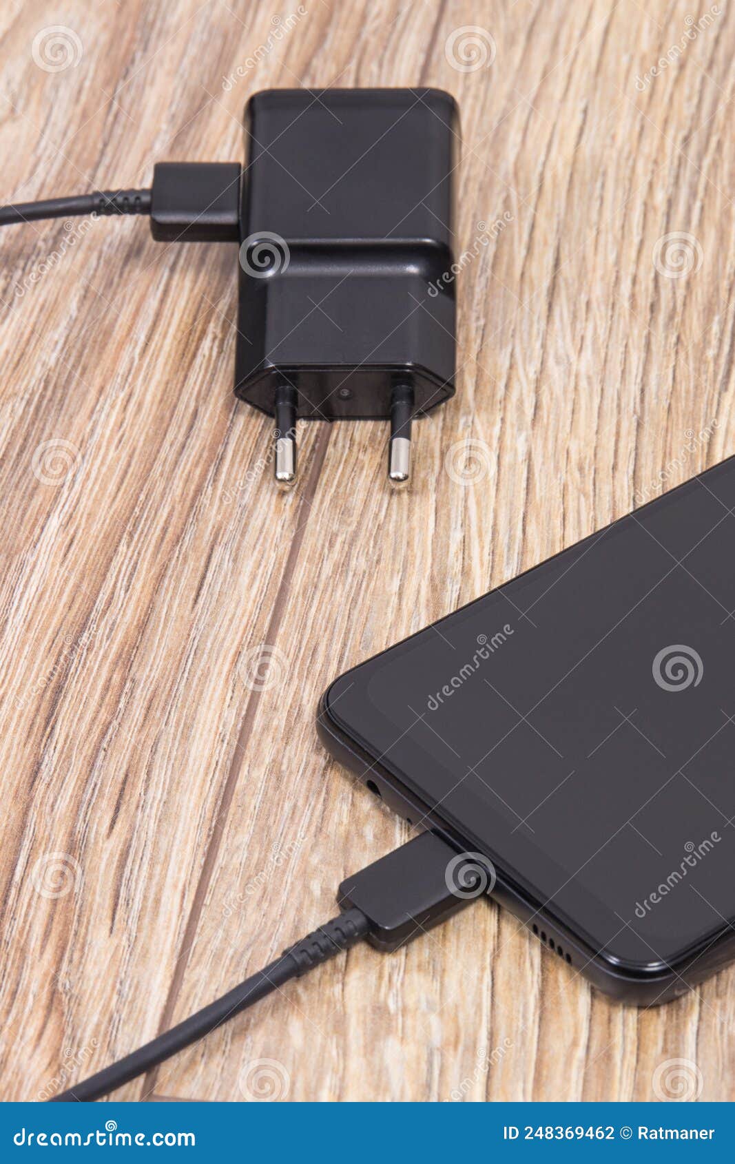 Black Smartphone with Charger. Various Devices Charging Concept Stock