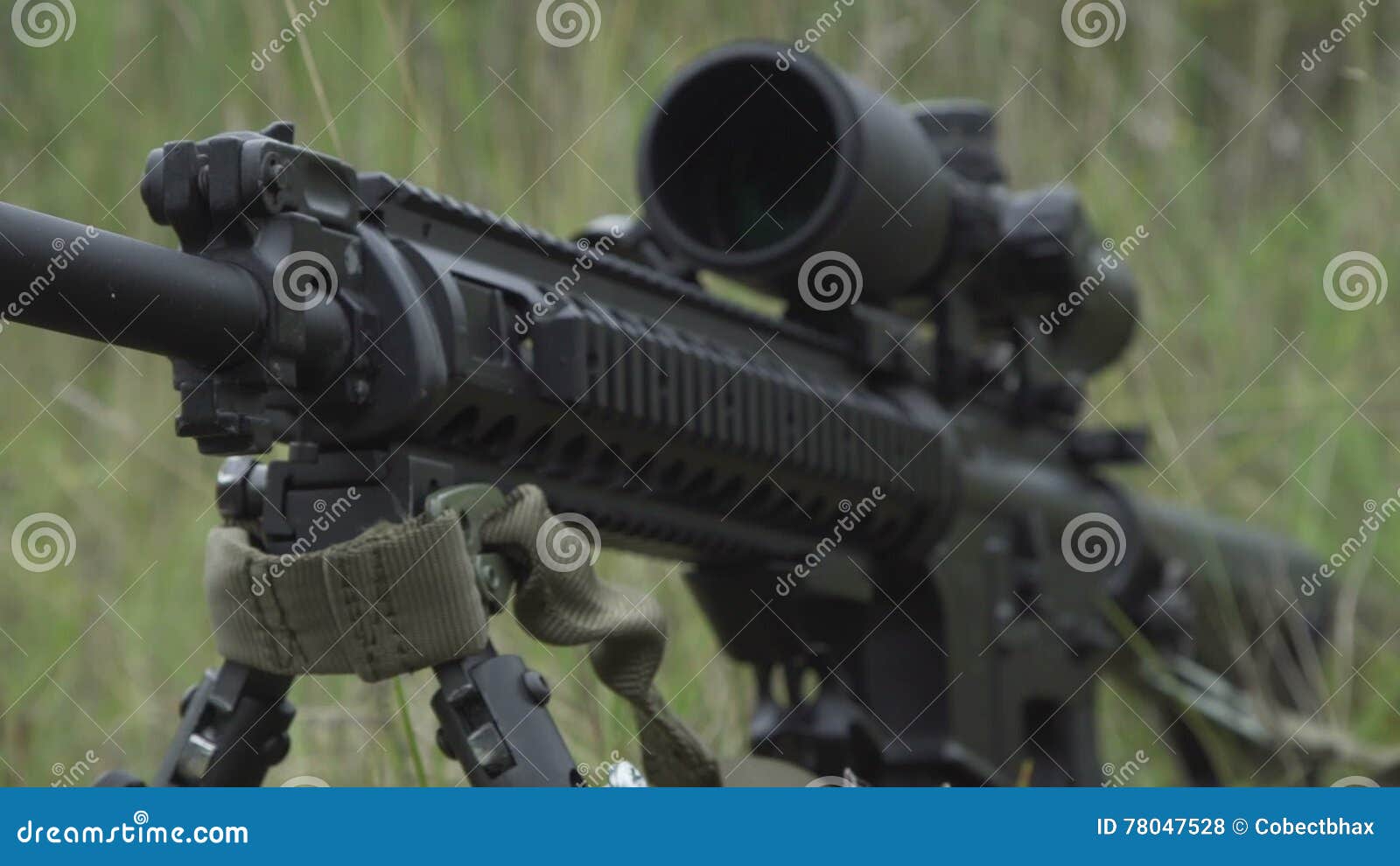 Black Sniper Rifle is on the Ground in the Grass. Airsoft Guns Stock