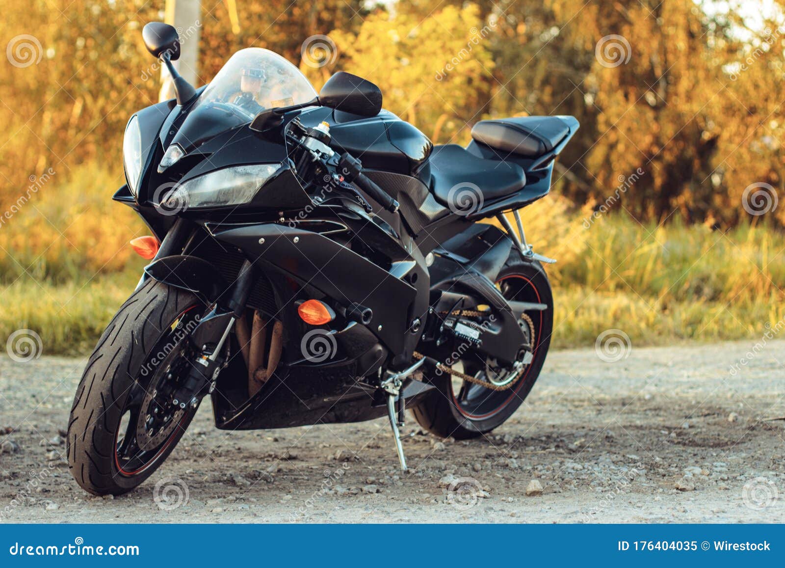 Black Sport Bike Parked on the Road with the Trees in the ...