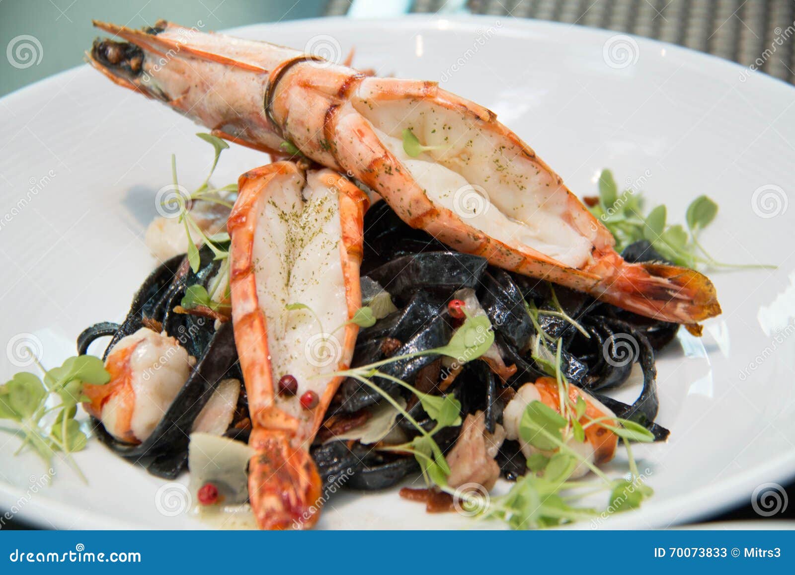 Black Squid Ink Pasta is Paired with Scallops on Pasta Stock Image