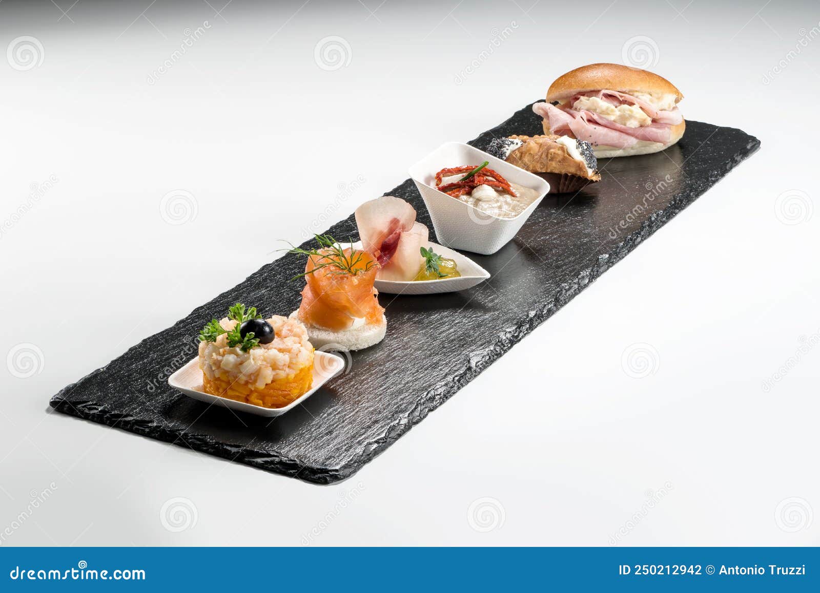 black stone rectangular tray with shrimp tartare snack cannoli swordfish ravioli with robbiola tartina nordica mousse aubergine