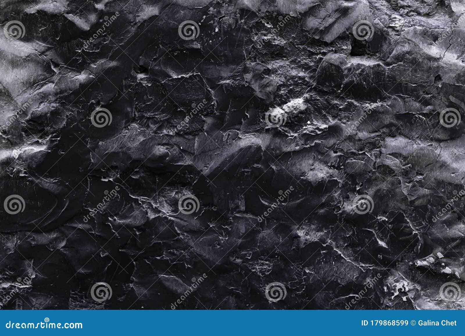 A Black Stone Surface with an Uneven Texture in the Form of Bulges and