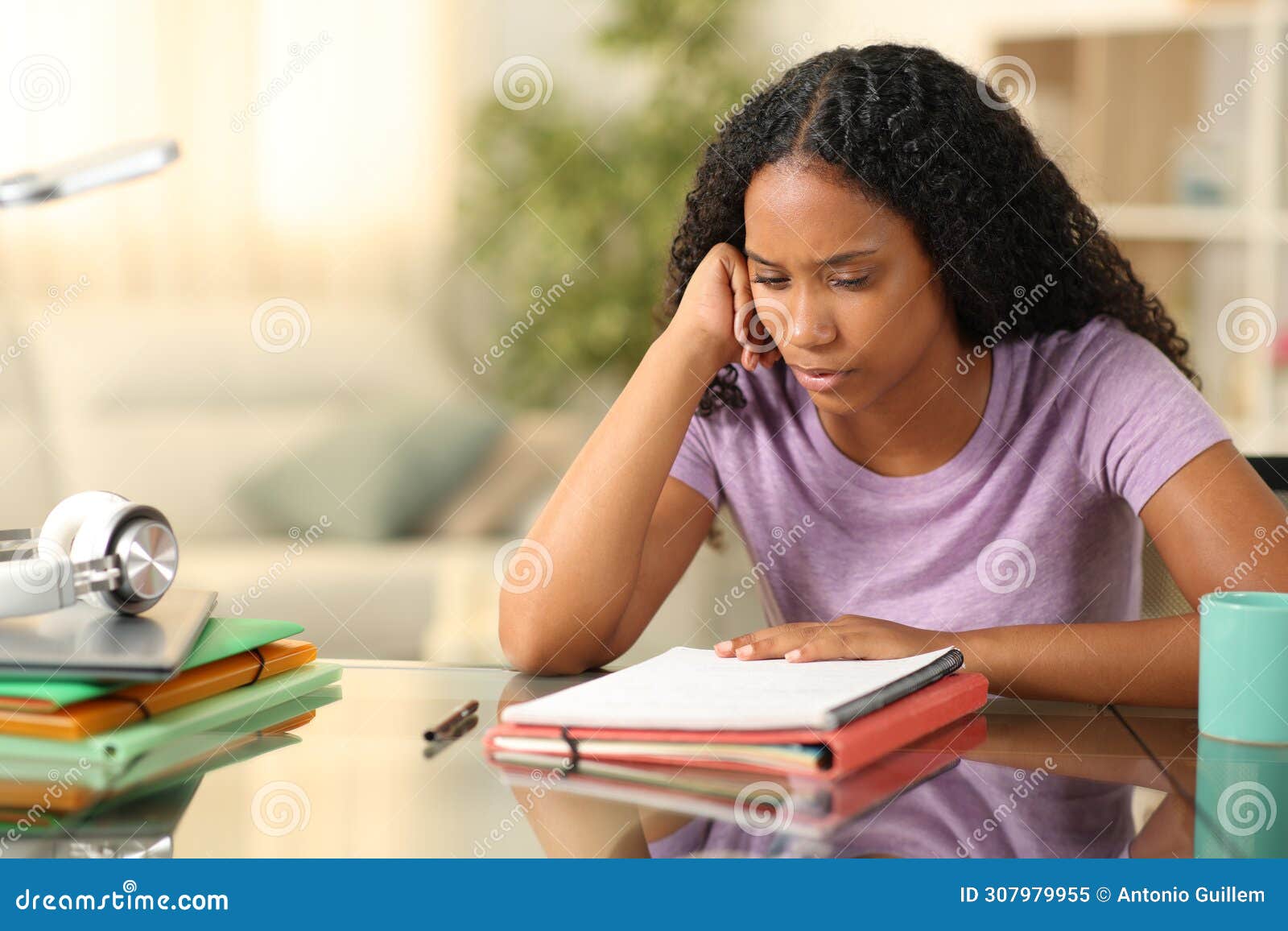 black student studying memorizing notes at home