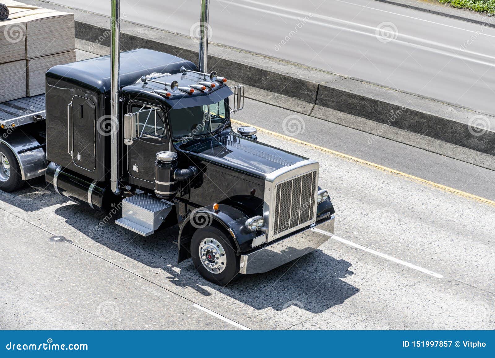 Black Powerful Big Rig Classic Semi Truck Transporting Cargo on Flat Bed  Semi Trailer Moving on Multiline Highway Stock Image - Image of direction,  highway: 151997857